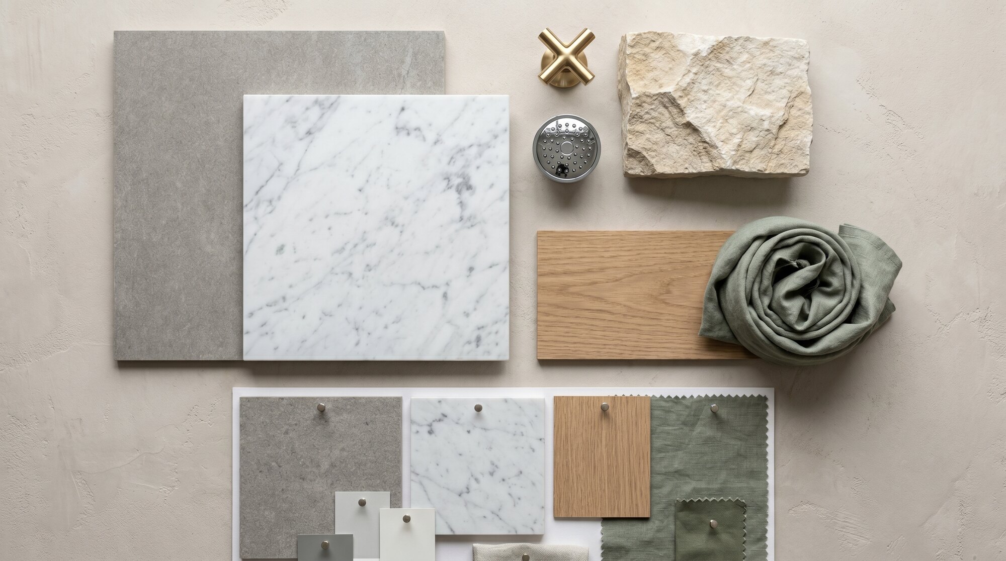 A flat-lay of bathroom materials — tile, stone and timber samples.